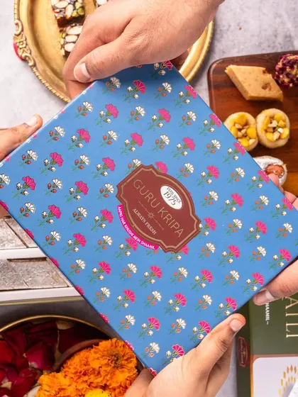 Packaging is a key part of the product experience. In this shot, we focused on the human element of gifting, showing hands exchanging a beautifully designed box of fresh sweets from Guru Kripa.