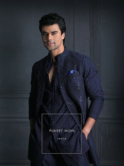 Unveil your dashing side this Sangeet. My bespoke Indo-Fusion ensemble boasts stunning geometric embellishments and sleek multiple loop button detailing.