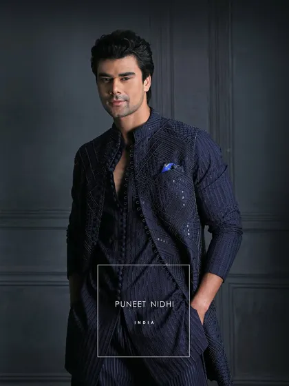 Unveil your dashing side this Sangeet. My bespoke Indo-Fusion ensemble boasts stunning geometric embellishments and sleek multiple loop button detailing.