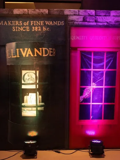 A storefront setup of Diagon Alley shops, including Ollivanders wand shop, complete with magical lighting and details.