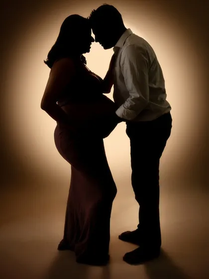 Another take on the power of a silhouette. Here, the couple's connection is highlighted by the warm glow behind them, creating an intimate and artistic portrait that focuses on their bond.