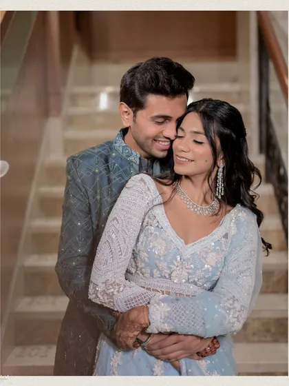A warm and affectionate embrace from behind. This pose is perfect for showing off the back details of the bride's blouse and creating a sense of closeness and protection.
