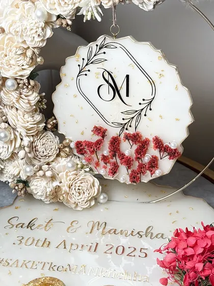 Detail of the hanging monogram piece, showing the delicate floral work and the elegant initial design.