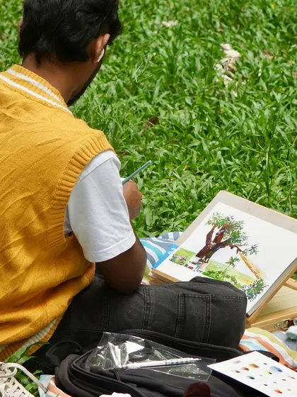From the back, you can see how I build up a painting. Starting with a light sketch, I add layers of watercolor to create the form of the tree and the people sitting under it.
