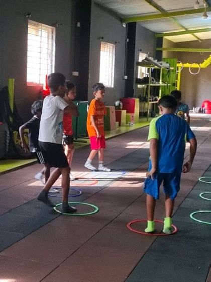 A group of kids engaged in a fun and dynamic warm-up game.