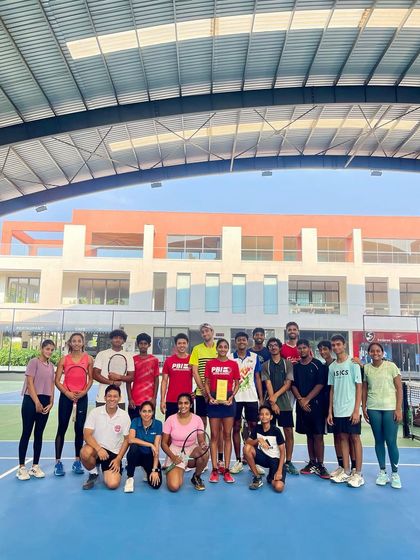 The PBI family celebrates a player's AITA Doubles Championship. Her victory is a victory for the entire team that supported her journey.