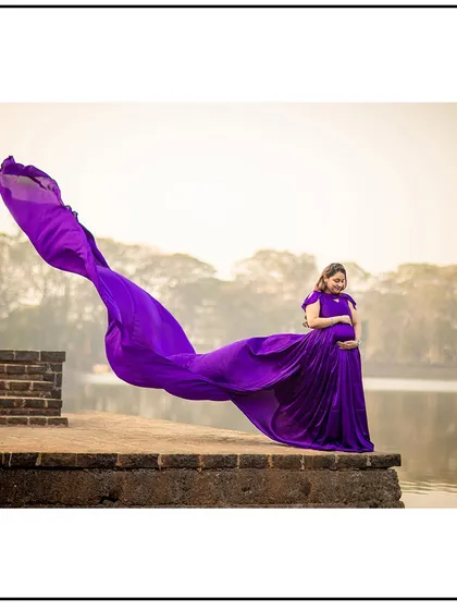 A breathtaking shot of the purple gown's train flying in the wind, creating a magical and artistic solo portrait.