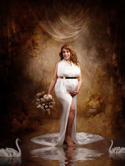 A serene portrait set in a magical swan lake scene. The client, in a beautiful white gown, holds a rustic bouquet, creating a look of timeless elegance against the painterly backdrop.