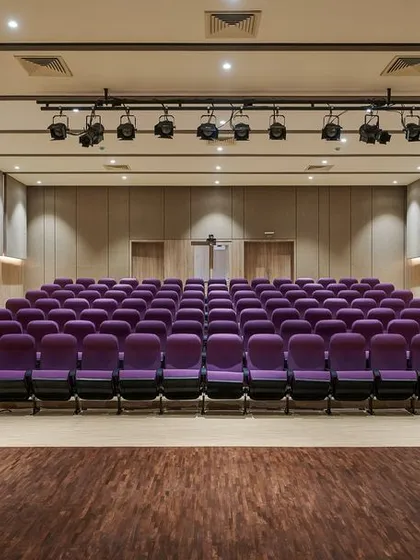 The 100-seater auditorium at the KIPCER building in Bengaluru. We designed this interior space with a warm, neutral palette of beige and brown to create a welcoming and focused environment for learning and knowledge sharing in palliative care.