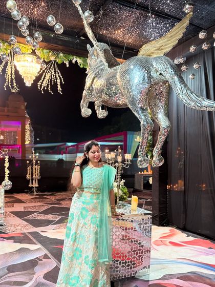 Posing by the grand decor. I am there to support my clients through the entire event, ensuring their performances go smoothly from start to finish.