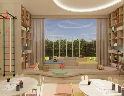 This playroom features floor-to-ceiling bookshelves for storage and a large staged seating area by the window, creating a perfect reading nook with a view of the outdoors.