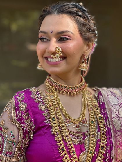 A close-up capturing the bride's joyful expression and the classic Chandrakor bindi.