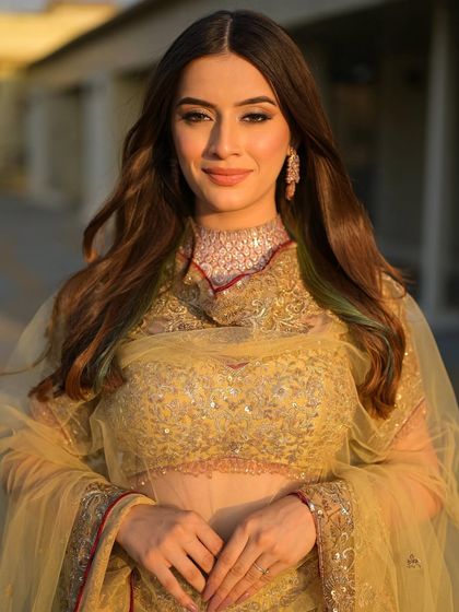 Bathed in the golden hour light, this bride looks absolutely radiant. Her soft, traditional makeup is perfect for a daytime wedding or outdoor event.