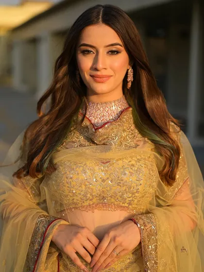 Bathed in the golden hour light, this bride looks absolutely radiant. Her soft, traditional makeup is perfect for a daytime wedding or outdoor event.