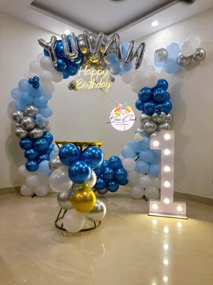 A blue, white, and silver balloon ring with a marquee number '1' and foil letters for a birthday.