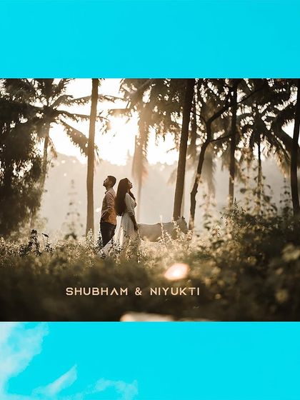 A beautifully composed shot of a couple standing amidst palm trees at sunrise, with their names elegantly overlaid.