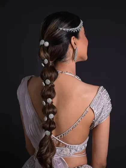 This modern bubble braid is perfect for a cocktail party or sangeet. I used sparkling diamond-style accessories to catch the light and a sleek matha patti for a look that is both chic and unforgettable.