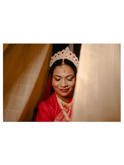 A serene portrait of the Bengali bride, her eyes closed, taking in the moment before the ceremony.