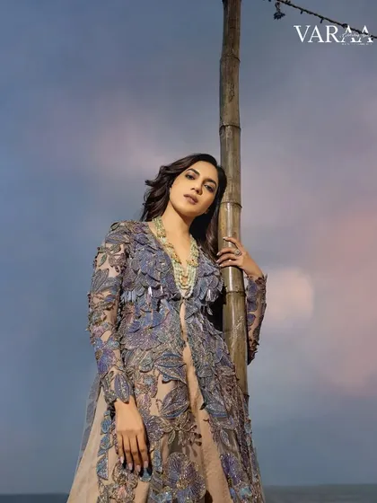 A closer look at the embroidered jacket from the Varaa shoot. The detailed floral embroidery and soft color palette create a romantic yet modern feel, perfect for an evening by the beach.