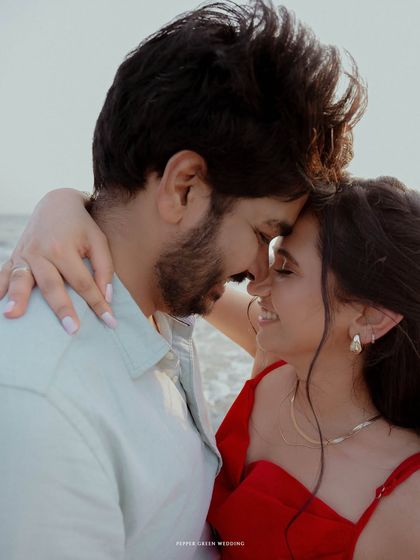 An intimate close-up, capturing the tender connection between the couple during their beach pre-wedding shoot.