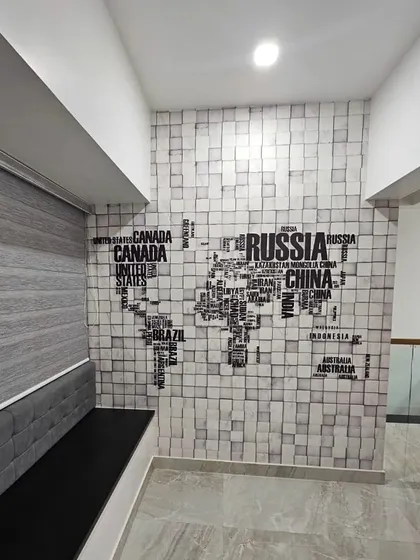 A world map made of typography on a 3D block pattern wallpaper. This is a creative and modern design, perfect for a study, office, or for anyone with a love for travel.