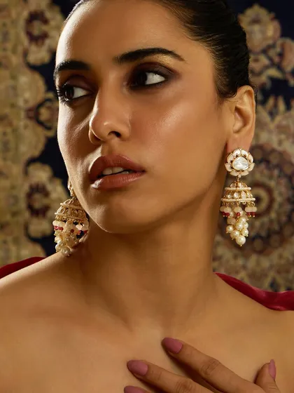 A model showcasing the same beautiful lotus jhumkas worn by Sargun Mehta, highlighting their versatility and timeless appeal.