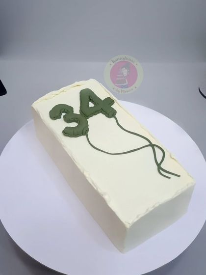 A minimalist rectangular cake with balloon-shaped numbers, perfect for a modern celebration.