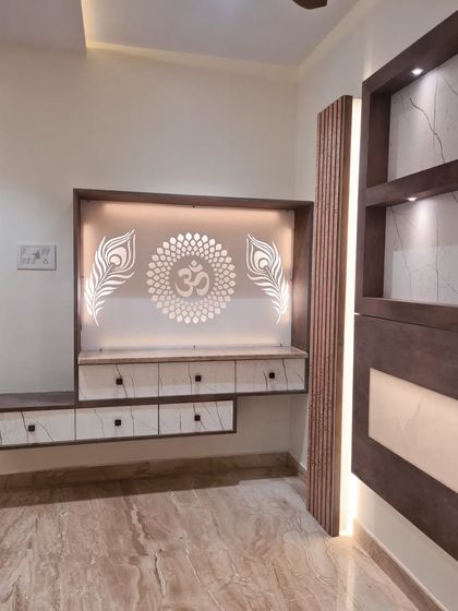 The backlit 'Om' symbol with peacock feathers adds a spiritual and artistic touch to this custom-designed media and pooja unit.