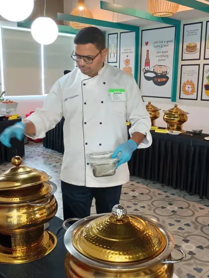 Our head chef overseeing a buffet spread. Our experienced culinary team ensures that every dish served meets our high standards of quality and taste.