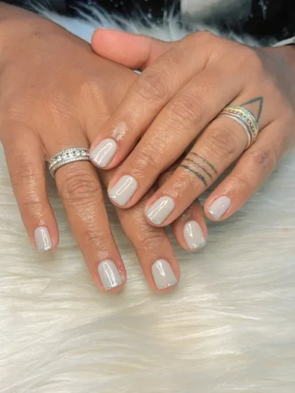 A simple gel polish application on short, natural nails. This light grey is a chic and modern neutral color.