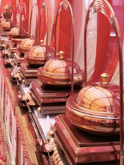 A close-up of our beautiful copper-toned, globe-style chafing dishes. We invest in high-quality, unique serveware to ensure your buffet not only tastes great but also looks spectacular.