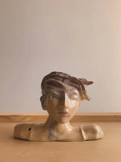 A self-taught artist's stunning work, a glazed bust with a dynamic, windswept hair effect. We were honored to provide kiln services for this piece.