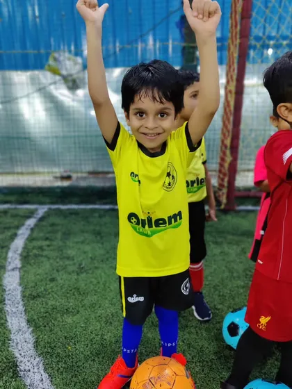Pure happiness. A young player from our toddlers' batch celebrates during a training session. We create memories that last a lifetime.
