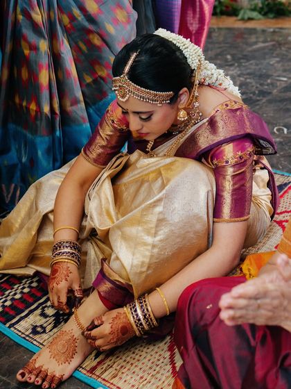 A shot capturing the intricate details of the ceremony and the bride's traditional attire, with her makeup looking perfect.