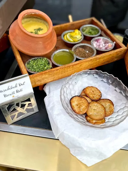 A taste of tradition. Slow-cooked Muradabadi Dal served with all the classic condiments and crispy, flaky Biscuiti Roti for a wholesome and authentic experience.