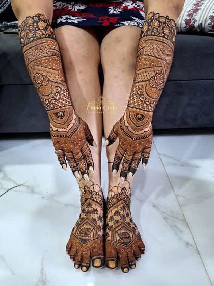 A full view of a magnificent bridal henna combination. This shows how we coordinate the intricate designs of the hands and arms with the equally detailed patterns on the feet and legs for a harmonious look.