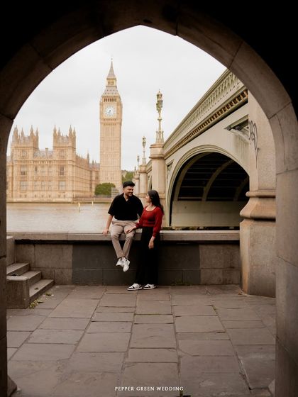 Devi and Milind sharing a quiet moment under an archway, with Big Ben in the distance. I love using architectural elements to frame couples and create visually interesting shots.