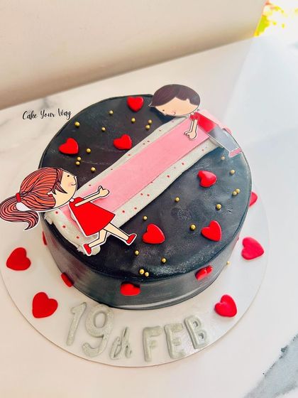 A sleek black version of the ribbon-pull cake, perfect for a modern celebration.