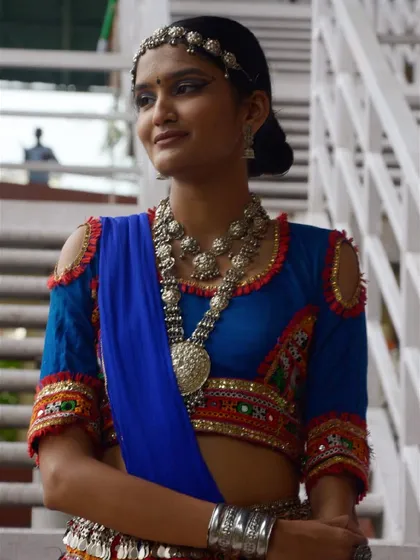 A stunning portrait in a royal blue and multi-colored chaniya choli. The heavy oxidized silver necklace makes a bold statement.