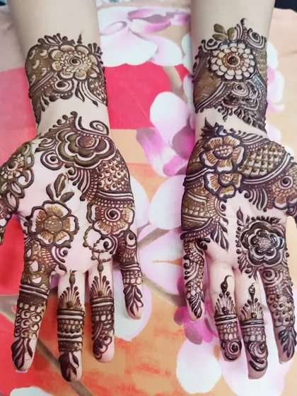 A beautiful example of Arabic-style mehndi, with a focus on bold floral and vine patterns with open spaces.