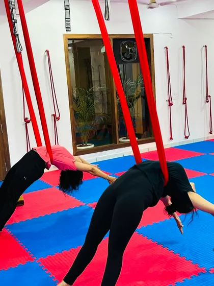 The hammock provides gentle support for deep backbends, allowing students to relax into the stretch and open their hearts more fully.