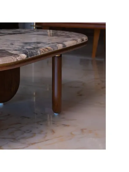 Another detail of the coffee table, highlighting the unique shape of its wooden legs.