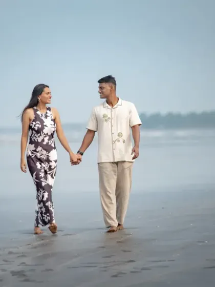 A serene walk along the shore during a pre-wedding shoot. The misty background and calm water create a peaceful and romantic atmosphere for this couple portrait.