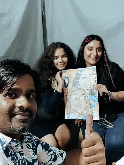 That's me with some happy customers. After finishing their group caricature, we had to take a picture. Seeing people enjoy my art is the best part of being a live event artist.