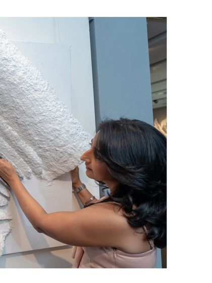 The final touches on "The Flight of Knowledge." The layered pages seem to lift off the canvas, symbolizing knowledge taking flight into the world.