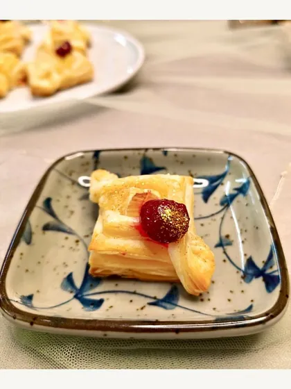 A delicate Brie & Cranberry Puff Pastry bite. This appetizer from our continental menu offers a perfect balance of creamy, sweet, and flaky textures.