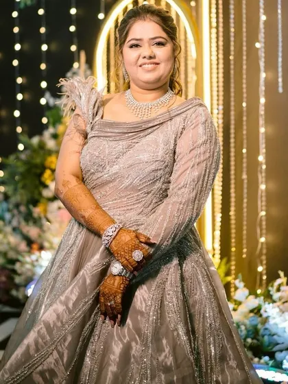 A full view of this stunning silver gown and the glamorous makeup that completes the look. Perfect for a reception or cocktail event.
