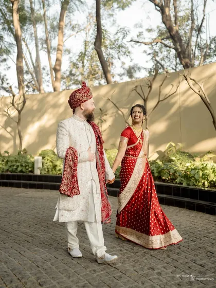 A candid moment during a walk. The bride's joyful glance back at her partner tells a story of love and excitement, perfectly capturing the spirit of their wedding day.