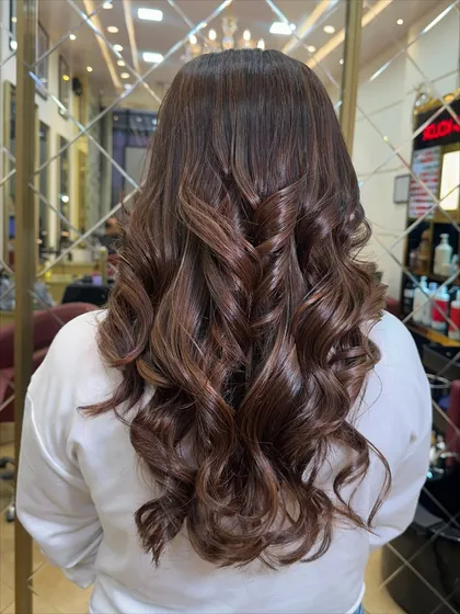 The back view of this hazelnut mocha look, styled into perfect curls. This showcases the dimension and shine that I aim for with every color service.