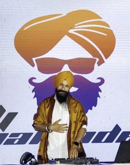 Standing proudly at my console in front of my personal brand logo. Setting goals is the first step in turning the invisible into the visible.